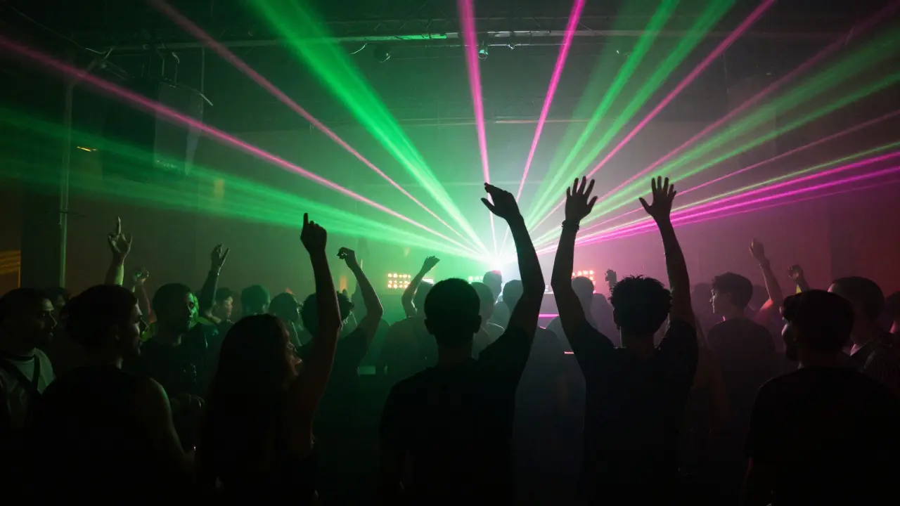 Dancers silhouetted on a floor lit by laser beams and haze